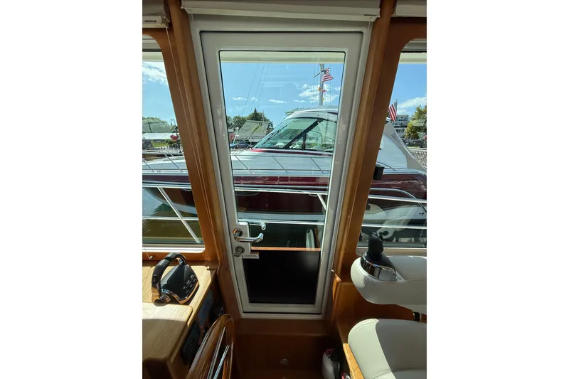 Slide: The Image of Interior view of 2018 Sabre 45 Salon Express yacht, showcasing helm and exterior scenery. - 47
