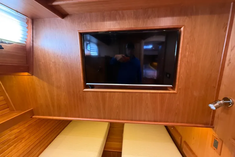 Slide: The Image of Interior of 2018 Sabre 45 Salon Express with wood paneling and built-in TV. - 63