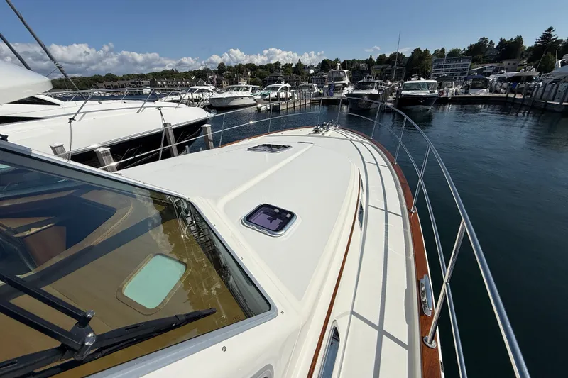 Slide: The Image of 2018 Sabre 45 Salon Express yacht docked at a marina, showcasing sleek design and craftsmanship. - 12