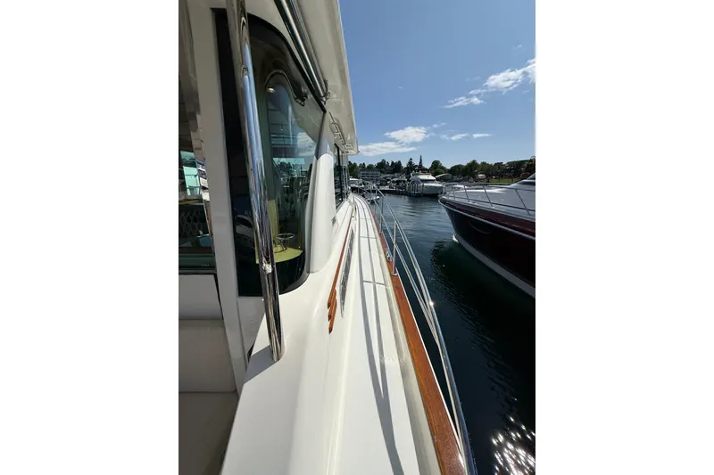 Slide: The Image of 2018 Sabre 45 Salon Express yacht docked, showcasing sleek design and polished railings. - 19