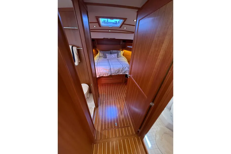 Slide: The Image of Luxurious 2018 Sabre 45 Salon Express cabin interior with wood finish and cozy bedding. - 54