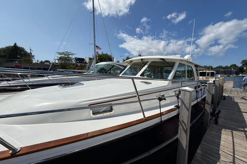 Slide: The Image of 2018 Sabre 45 Salon Express yacht docked under a clear blue sky. - 11
