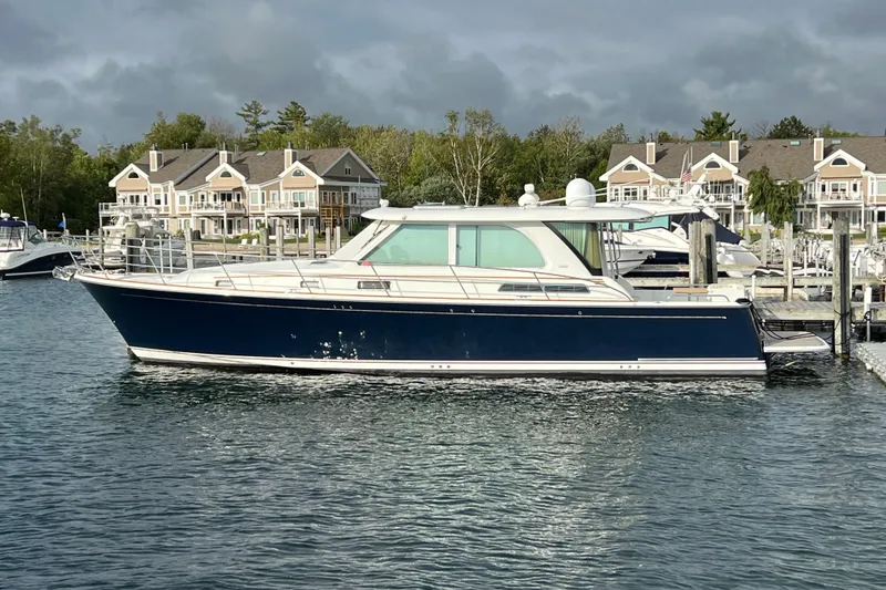 Slide: The Image of 2018 Sabre 45 Salon Express yacht docked near waterfront homes. - 3