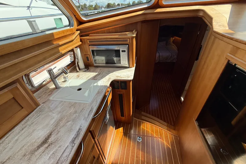 Slide: The Image of Interior of 2018 Sabre 45 Salon Express yacht with modern kitchen and wood finishes. - 49