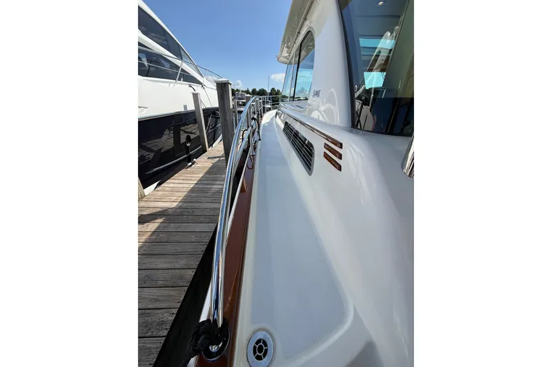 Slide: The Image of 2018 Sabre 45 Salon Express yacht docked, showcasing sleek design and polished railings. - 20