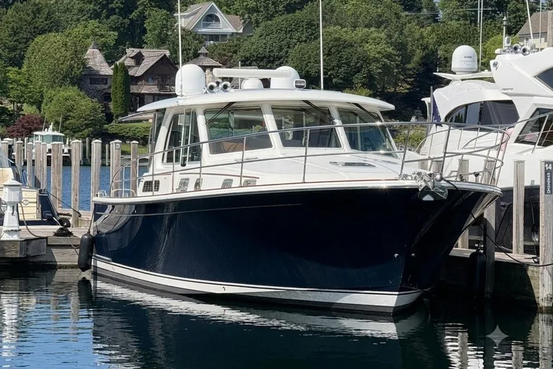 Slide: The Image of 2018 Sabre 45 Salon Express yacht docked in a scenic marina. - 7