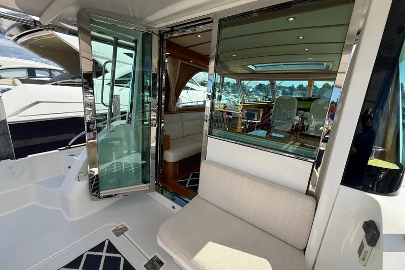 Slide: The Image of 2018 Sabre 45 Salon Express yacht interior with sliding glass doors and luxurious seating. - 23