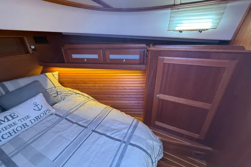 Slide: The Image of Cozy cabin interior of 2018 Sabre 45 Salon Express with wood paneling and soft lighting. - 57