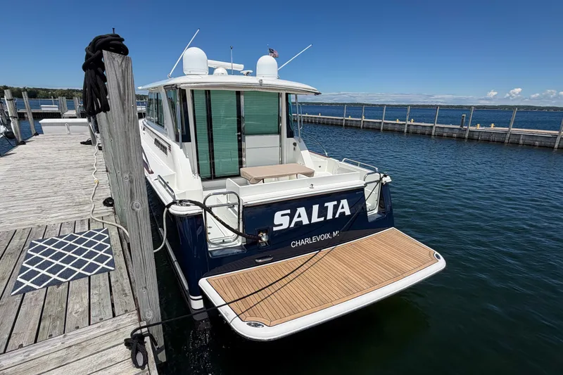Slide: The Image of 2018 Sabre 45 Salon Express yacht docked at a marina, clear blue sky. - 4