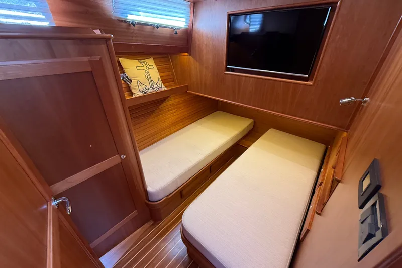 Slide: The Image of 2018 Sabre 45 Salon Express cabin with twin beds, wooden interior, and wall-mounted TV. - 61