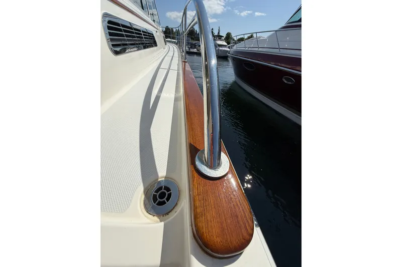 Slide: The Image of 2018 Sabre 45 Salon Express yacht deck with polished railing and wood accents. - 30