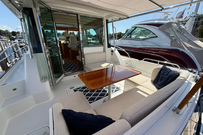Slide: The Image of 2018 Sabre 45 Salon Express yacht with elegant outdoor seating and wooden table. - 21