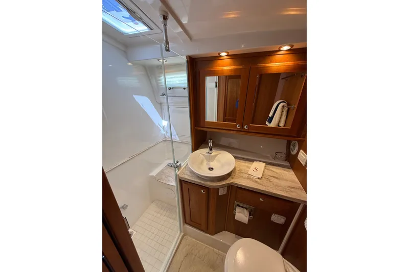 Slide: The Image of Luxurious bathroom in 2018 Sabre 45 Salon Express yacht with modern fixtures and wood accents. - 60