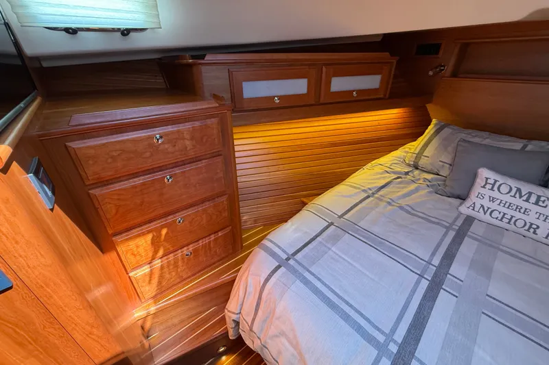 Slide: The Image of 2018 Sabre 45 Salon Express cabin with wooden cabinetry and cozy bedding. - 56