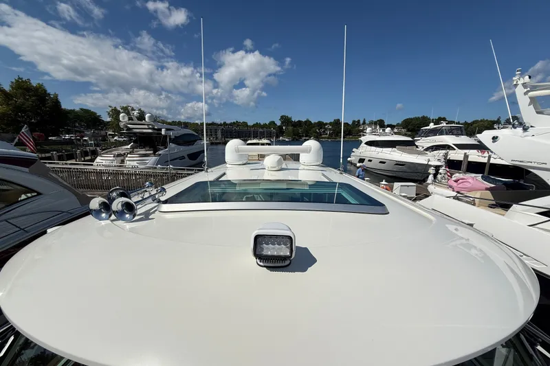 Slide: The Image of 2018 Sabre 45 Salon Express yacht docked at marina, surrounded by other luxury boats. - 18
