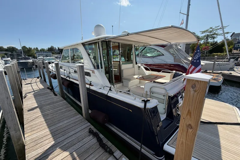 Slide: The Image of 2018 Sabre 45 Salon Express yacht docked at marina, featuring elegant design and spacious deck. - 10