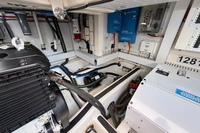 Slide: The Image of Engine room of a 2018 Sabre 45 Salon Express with visible wiring and components. - 70