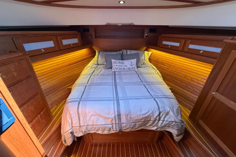 Slide: The Image of Cozy bedroom in 2018 Sabre 45 Salon Express yacht with warm wood paneling. - 55