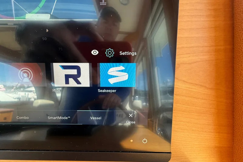 Slide: The Image of Touchscreen display on a 2018 Sabre 45 Salon Express yacht showing navigation and settings options. - 44