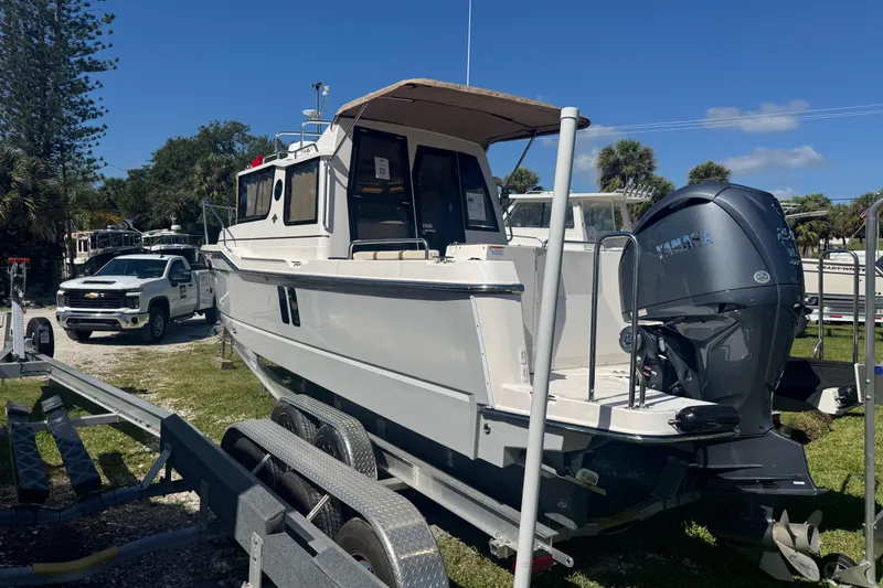Slide: The Image of 2026 Ranger Tugs R-25 boat on trailer with Yamaha outboard motor. - 2