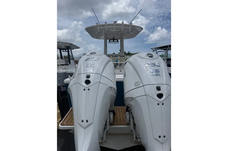 Slide: The Image of 2025 Regulator 25 boat with dual Yamaha 250 V6 outboard engines under a cloudy sky. - 15