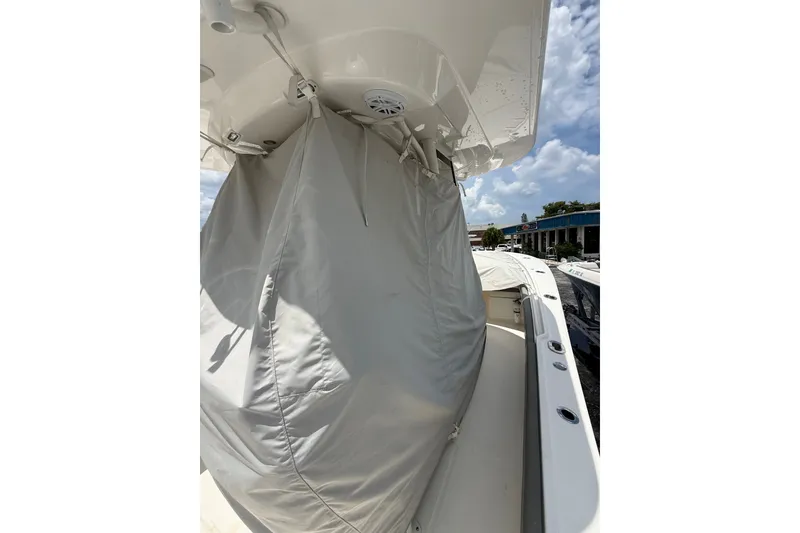 Slide: The Image of 2025 Regulator 25 boat with protective cover under a clear sky. - 26