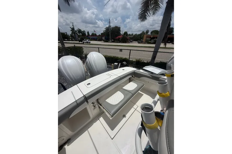 Slide: The Image of 2025 Regulator 25 boat interior with dual engines and seating under a sunny sky. - 16