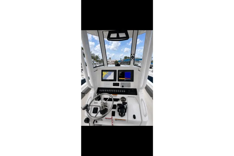 Slide: The Image of Cockpit of 2025 Regulator 25 boat with navigation screens and steering wheel. - 4