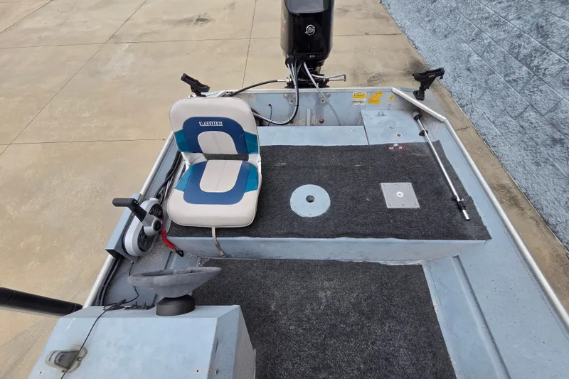 Slide: The Image of 1997 Lowe Bass Striker 170 boat interior with steering wheel and seating. - 6