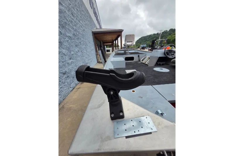 Slide: The Image of 1997 Lowe Bass Striker 170 boat with rod holder, docked outdoors. - 9