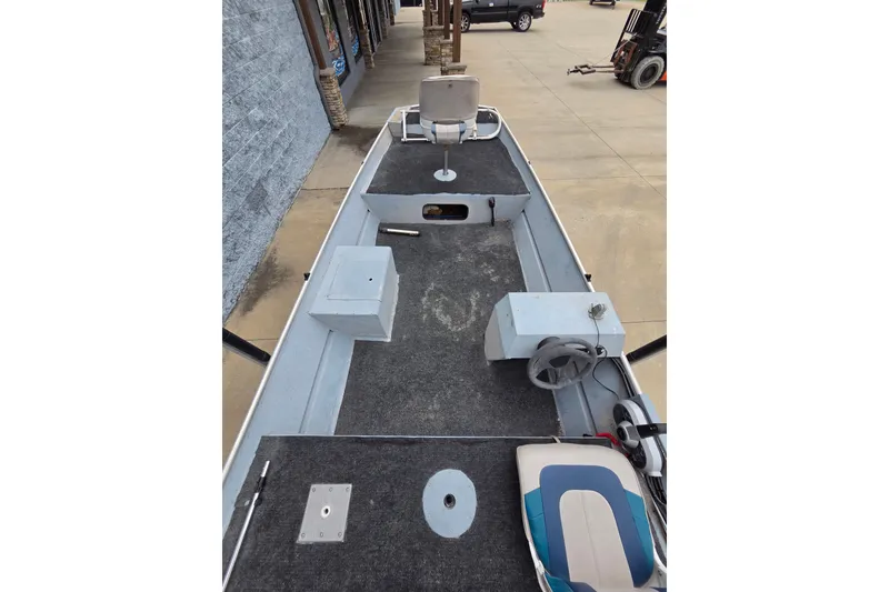 Slide: The Image of 1997 Lowe Bass Striker 170 boat interior with steering wheel and seating. - 7