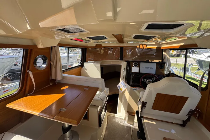 Slide: The Image of Interior of 2026 Ranger Tugs R-25 boat with seating and navigation equipment. - 9