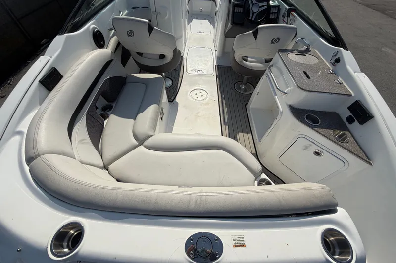 Slide: The Image of 2019 Hurricane SunDeck 2400 OB interior with seating, helm, and kitchenette. - 13