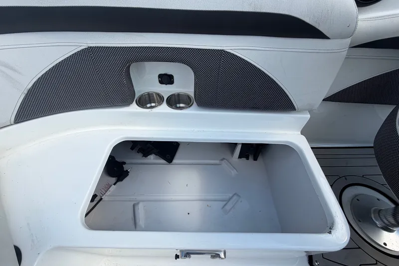Slide: The Image of 2019 Hurricane SunDeck 2400 OB boat storage compartment with cup holders and seating area. - 66