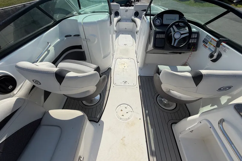 Slide: The Image of 2019 Hurricane SunDeck 2400 OB boat interior with seating and steering console. - 19