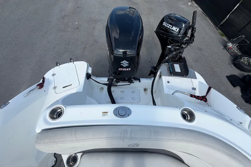 Slide: The Image of 2019 Hurricane SunDeck 2400 OB boat with Suzuki outboard motor, rear view. - 71