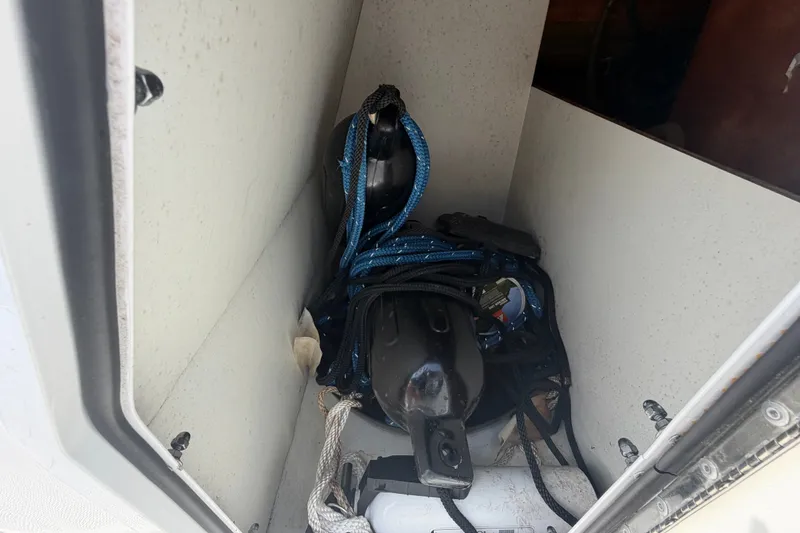 Slide: The Image of Storage compartment of 2019 Hurricane SunDeck 2400 OB with ropes and equipment. - 58