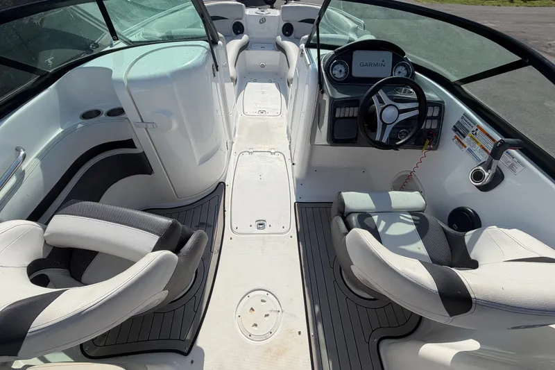 Slide: The Image of 2019 Hurricane SunDeck 2400 OB boat interior with steering wheel and seating. - 20