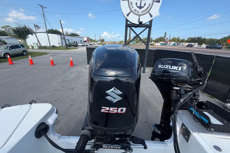 Slide: The Image of 2019 Hurricane SunDeck 2400 OB with Suzuki 250 outboard motor in parking lot. - 73