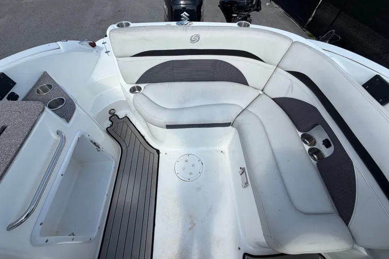 Slide: The Image of 2019 Hurricane SunDeck 2400 OB boat interior with white seating and cup holders. - 63