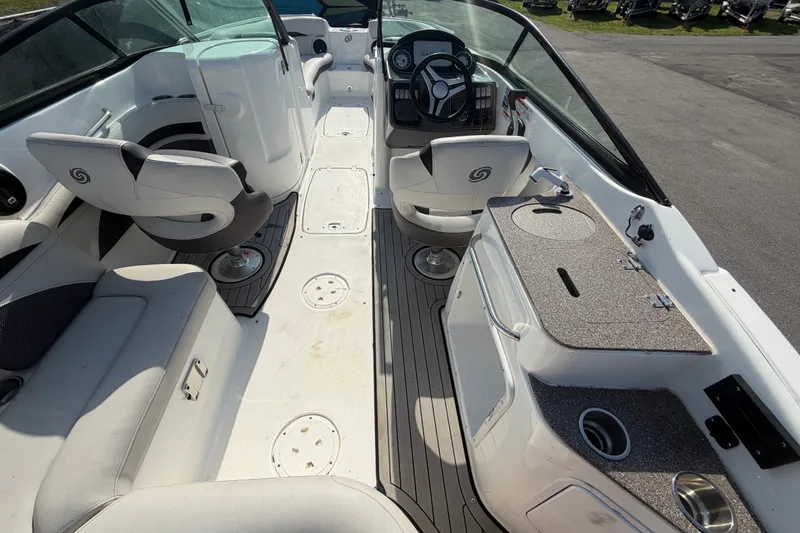 Slide: The Image of 2019 Hurricane SunDeck 2400 OB boat interior with seating and helm, showcasing modern design. - 16