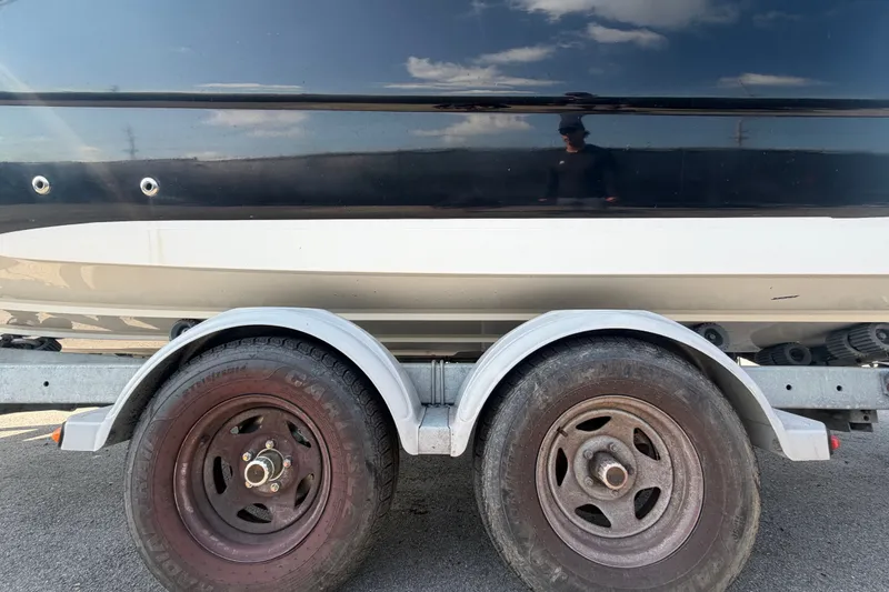 Slide: The Image of 2019 Hurricane SunDeck 2400 OB boat on trailer, close-up of wheels and hull. - 82