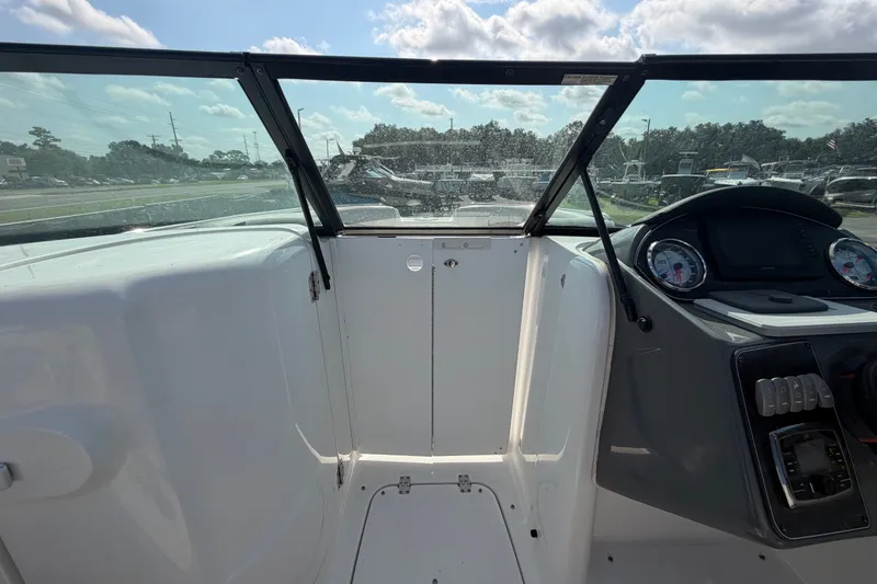 Slide: The Image of 2019 Hurricane SunDeck 2400 OB boat cockpit with windshield and control panel. - 39