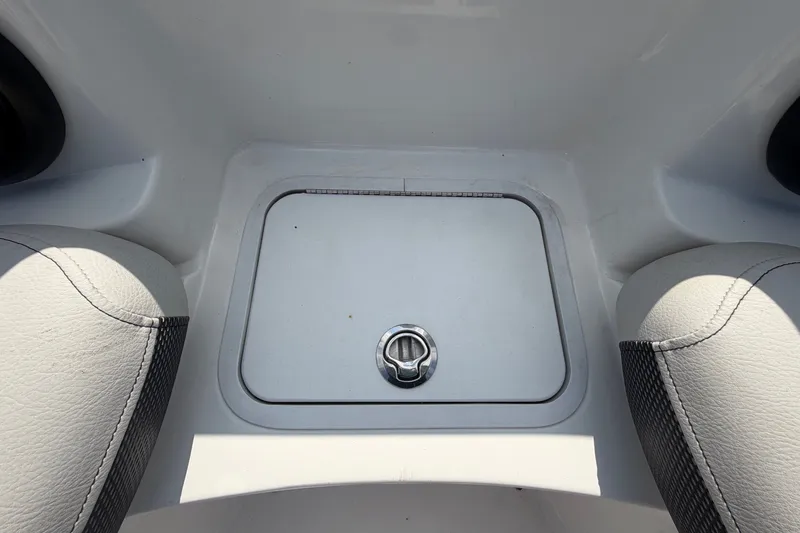 Slide: The Image of A storage hatch on a boat with cushioned seats beside it. - 47