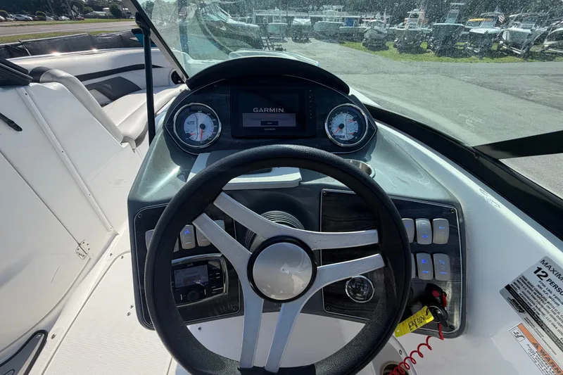 Slide: The Image of 2019 Hurricane SunDeck 2400 OB boat dashboard with Garmin display and steering wheel. - 29