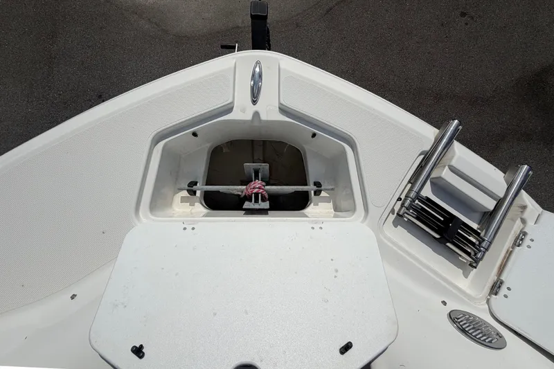 Slide: The Image of Bow of a Hurricane SunDeck 2400 OB with anchor compartment and ladder. - 50