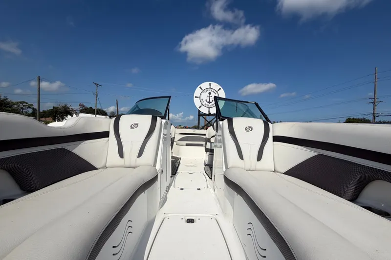 Slide: The Image of 2019 Hurricane SunDeck 2400 OB boat interior with white seating under blue sky. - 54
