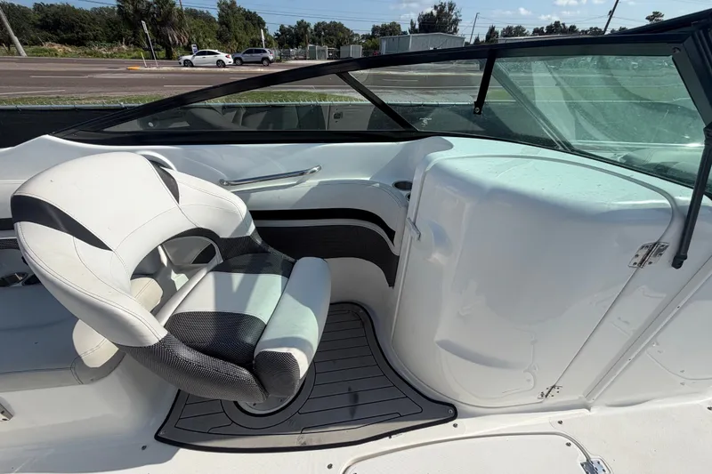 Slide: The Image of 2019 Hurricane SunDeck 2400 OB boat interior with captain's chair and windshield. - 22