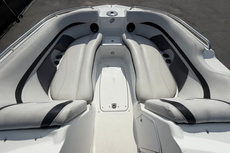Slide: The Image of 2019 Hurricane SunDeck 2400 OB boat interior with white cushioned seating and cup holders. - 40