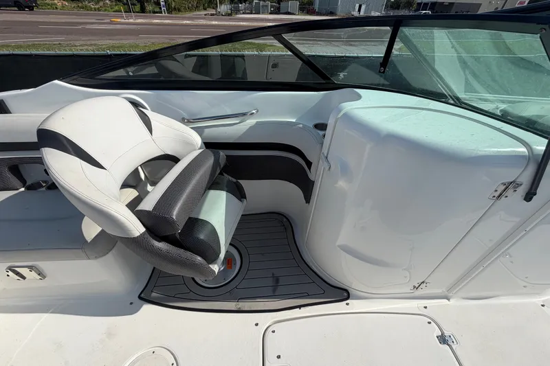 Slide: The Image of 2019 Hurricane SunDeck 2400 OB boat interior with swivel captain's chair and sleek dashboard. - 21